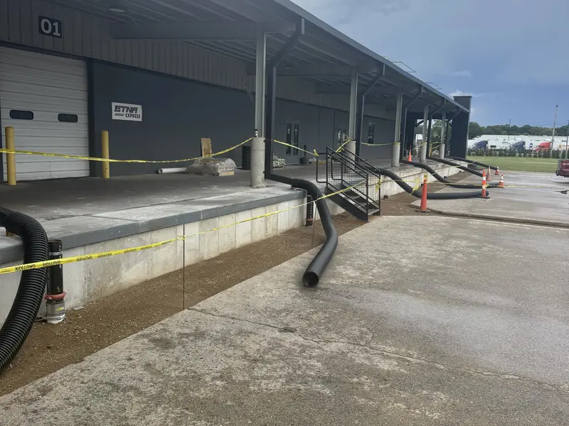 New concrete apron and retaining wall along a commercial loading dock